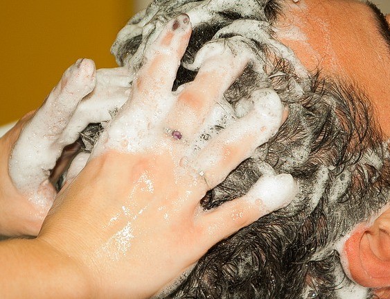 mans hair being washed