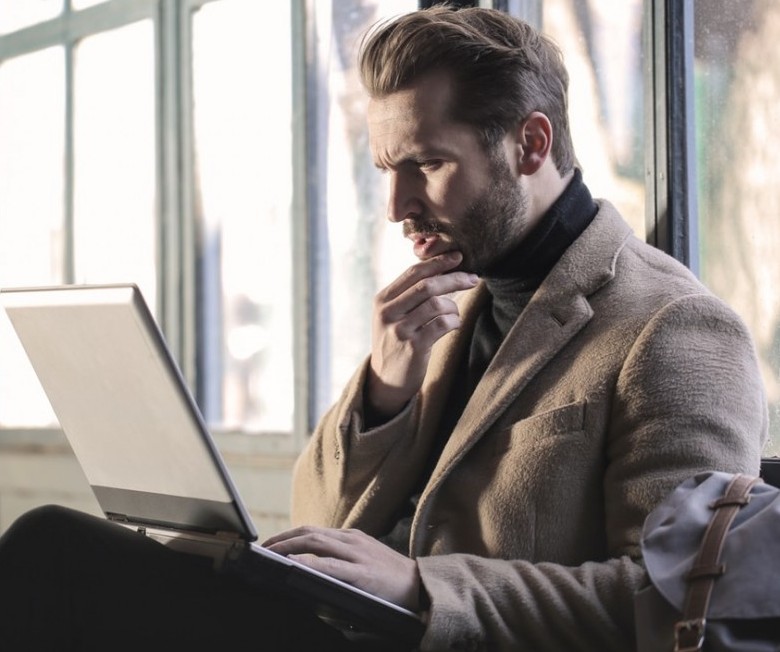 Man Looking For Information On Computer