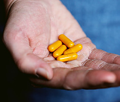 Hand with supplements in