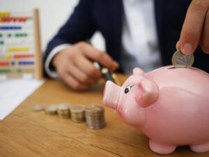 piggy bank with man stacking coins